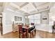Elegant dining room featuring coffered ceilings, hardwood floors, and wainscoting, perfect for formal gatherings at 2325 Lake Cove Ct, Buford, GA 30519