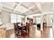 Elegant dining room with coffered ceiling, hardwood floors, and large windows at 2325 Lake Cove Ct, Buford, GA 30519