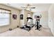 Spacious exercise room with treadmill, elliptical, free weights, and ceiling fan at 2325 Lake Cove Ct, Buford, GA 30519