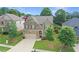 Charming two-story home with stone accents, a well-manicured lawn, and mature trees in a desirable neighborhood at 2325 Lake Cove Ct, Buford, GA 30519
