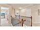 Hallway with carpet, wood railing, and doors to rooms at 2325 Lake Cove Ct, Buford, GA 30519