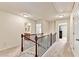 Hallway with carpet, wood railing, and doors to rooms at 2325 Lake Cove Ct, Buford, GA 30519