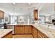 This open kitchen features granite countertops, stainless steel appliances, and an island with barstool seating at 2325 Lake Cove Ct, Buford, GA 30519