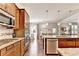 This open kitchen features granite countertops, stainless steel appliances, and an island with barstool seating at 2325 Lake Cove Ct, Buford, GA 30519