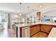 This eat-in kitchen features granite countertops, stainless steel appliances, and an island with barstool seating at 2325 Lake Cove Ct, Buford, GA 30519