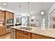 This open kitchen features granite countertops, stainless steel appliances, and an island with barstool seating at 2325 Lake Cove Ct, Buford, GA 30519