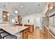 This open kitchen features granite countertops, stainless steel appliances, and a large island with barstool seating at 2325 Lake Cove Ct, Buford, GA 30519