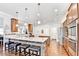Spacious kitchen with wood floors, granite countertops, stainless steel appliances, and a large center island at 2325 Lake Cove Ct, Buford, GA 30519