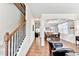 Open-concept living area featuring hardwood floors, staircase, and dining room in a bright, modern home at 2325 Lake Cove Ct, Buford, GA 30519
