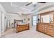 Spacious main bedroom with tray ceiling, ceiling fan, plush carpet, and wooden furniture at 2325 Lake Cove Ct, Buford, GA 30519