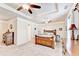Bright main bedroom featuring a tray ceiling, ceiling fan, carpet, and wooden furniture at 2325 Lake Cove Ct, Buford, GA 30519