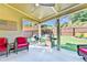 Covered patio featuring comfortable seating, ceiling fan, grilling area, and a view of the fenced backyard at 2325 Lake Cove Ct, Buford, GA 30519