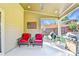 Covered patio features wicker seating, an American flag, and an outdoor grilling area overlooking the backyard at 2325 Lake Cove Ct, Buford, GA 30519