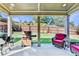 A cozy covered patio area featuring comfortable seating and an outdoor grilling area overlooking the fenced backyard at 2325 Lake Cove Ct, Buford, GA 30519