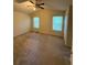 Spacious bedroom with neutral carpet, complemented by a ceiling fan and natural light through the windows at 2765 Dahlonega Trl, Austell, GA 30106