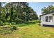 Spacious backyard featuring lush green grass and mature trees at 5619 Beaver Sw Dr, Mableton, GA 30126
