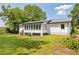 Well-manicured backyard with lots of green grass and mature trees at 5619 Beaver Sw Dr, Mableton, GA 30126