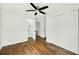 Bright bedroom featuring hardwood floors, a ceiling fan, closet, and a bathroom at 5619 Beaver Sw Dr, Mableton, GA 30126