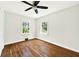 Bedroom featuring hardwood floors, neutral walls, two windows, and a ceiling fan at 5619 Beaver Sw Dr, Mableton, GA 30126