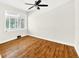 Bright bedroom featuring hardwood floors, white walls, large windows, and a modern ceiling fan at 5619 Beaver Sw Dr, Mableton, GA 30126