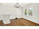 Bright dining area with white walls, modern light fixture, and hardwood floors at 5619 Beaver Sw Dr, Mableton, GA 30126