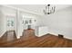 Dining area with stylish chandelier, white walls and hardwood floors, open to kitchen at 5619 Beaver Sw Dr, Mableton, GA 30126