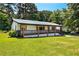Inviting single-story home with a full front porch, metal roof and lush green lawn at 5619 Beaver Sw Dr, Mableton, GA 30126