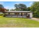 Attractive single-story house featuring a charming front porch, garage, and green lawn at 5619 Beaver Sw Dr, Mableton, GA 30126