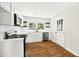 Bright kitchen with hardwood floors, stainless steel dishwasher, bright white cabinets and natural light at 5619 Beaver Sw Dr, Mableton, GA 30126