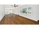 Open-concept living room with hardwood floors, white walls and a modern ceiling fan at 5619 Beaver Sw Dr, Mableton, GA 30126