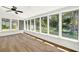 Inviting sunroom filled with an abundance of natural light, hardwood floors and ceiling fan at 5619 Beaver Sw Dr, Mableton, GA 30126