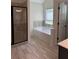 Main bathroom with walk in shower, tub and natural light at 5890 Crowley Dr, Douglasville, GA 30135