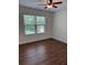 Cozy bedroom with natural light, ceiling fan, and views of exterior landscape at 5890 Crowley Dr, Douglasville, GA 30135