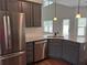 Kitchen featuring stainless steel appliances, gray cabinets, and granite countertops at 5890 Crowley Dr, Douglasville, GA 30135