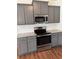 Bright kitchen featuring stainless steel appliances and gray cabinets at 5890 Crowley Dr, Douglasville, GA 30135