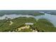 An aerial view of the neighborhood shows the home's location near the lake and surrounding forests at 619 Lovinggood Trl, Woodstock, GA 30189