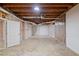 Unfinished basement space, with concrete floor and exposed framing, offering potential for customization at 619 Lovinggood Trl, Woodstock, GA 30189
