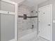 Bathroom featuring a tub with marble tile surround and a built-in shower niche at 619 Lovinggood Trl, Woodstock, GA 30189