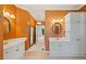 Bathroom with dual sinks, framed mirrors, and white cabinetry providing ample storage at 619 Lovinggood Trl, Woodstock, GA 30189