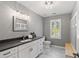 Elegant bathroom featuring a white vanity, black countertop, and marble tile flooring at 619 Lovinggood Trl, Woodstock, GA 30189