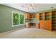 Bedroom featuring a large window, built-in shelves, and a ceiling fan at 619 Lovinggood Trl, Woodstock, GA 30189