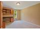 Bedroom featuring custom built-ins, desk, and plush carpeting at 619 Lovinggood Trl, Woodstock, GA 30189