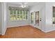 Breakfast room with tiled floor, ceiling fan and plantation shutters with backyard view at 619 Lovinggood Trl, Woodstock, GA 30189