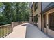Spacious wooden deck overlooking a lush, green backyard with mature trees and landscaping at 619 Lovinggood Trl, Woodstock, GA 30189