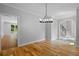 Open dining room leading to the living room and featuring hardwood floors at 619 Lovinggood Trl, Woodstock, GA 30189