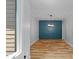 Dining room features a statement wall, chandelier, and hardwood flooring at 619 Lovinggood Trl, Woodstock, GA 30189