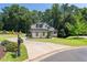 Beautiful home featuring manicured landscaping, a circular driveway, and lush green lawn at 619 Lovinggood Trl, Woodstock, GA 30189