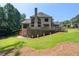 This spacious backyard features a large deck, walkout basement, and beautifully maintained lawn at 619 Lovinggood Trl, Woodstock, GA 30189