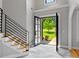 Bright foyer featuring stairs with wrought iron railing and view of exterior at 619 Lovinggood Trl, Woodstock, GA 30189