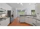 Spacious kitchen with stainless appliances, white cabinetry and breakfast bar at 619 Lovinggood Trl, Woodstock, GA 30189